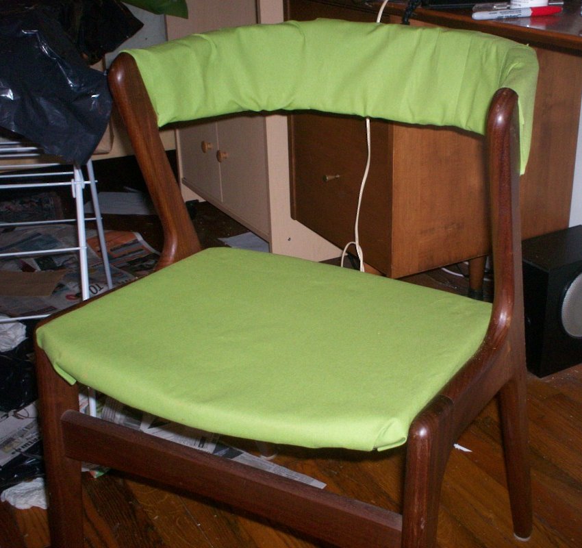 Sloppily assembled green chair with staples exposed