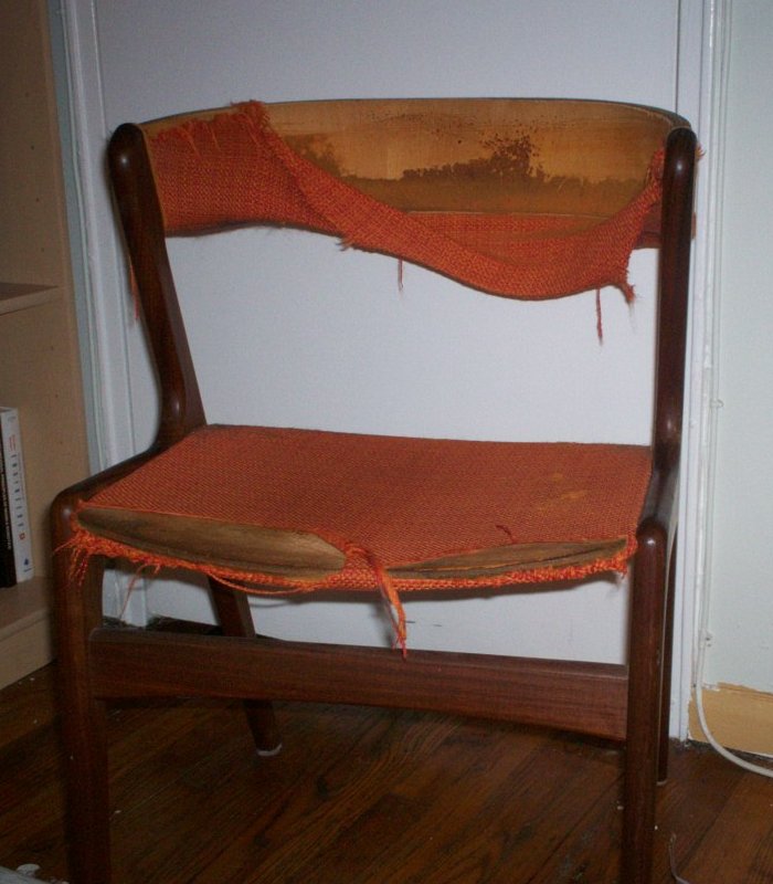Tattered orange chair with dissolving padding